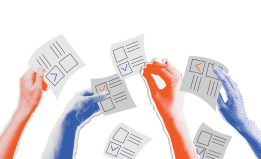 Hands holding filled-out ballots