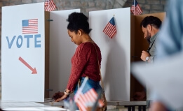 African American woman at voting booth during US elections
