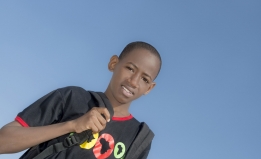 stock photo of a school aged youth of color wearing a backpack