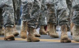 the feet of walking military troops