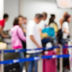 People waiting in line for security screening at an airport