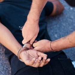 Person on the ground being handcuffed