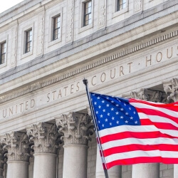 U.S. flag waving in the wind in front of United States Court House