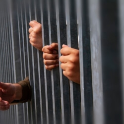 hands behind bars