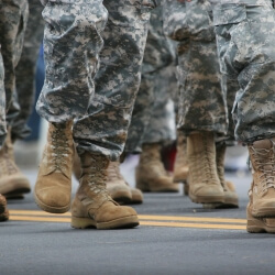 the feet of walking military troops