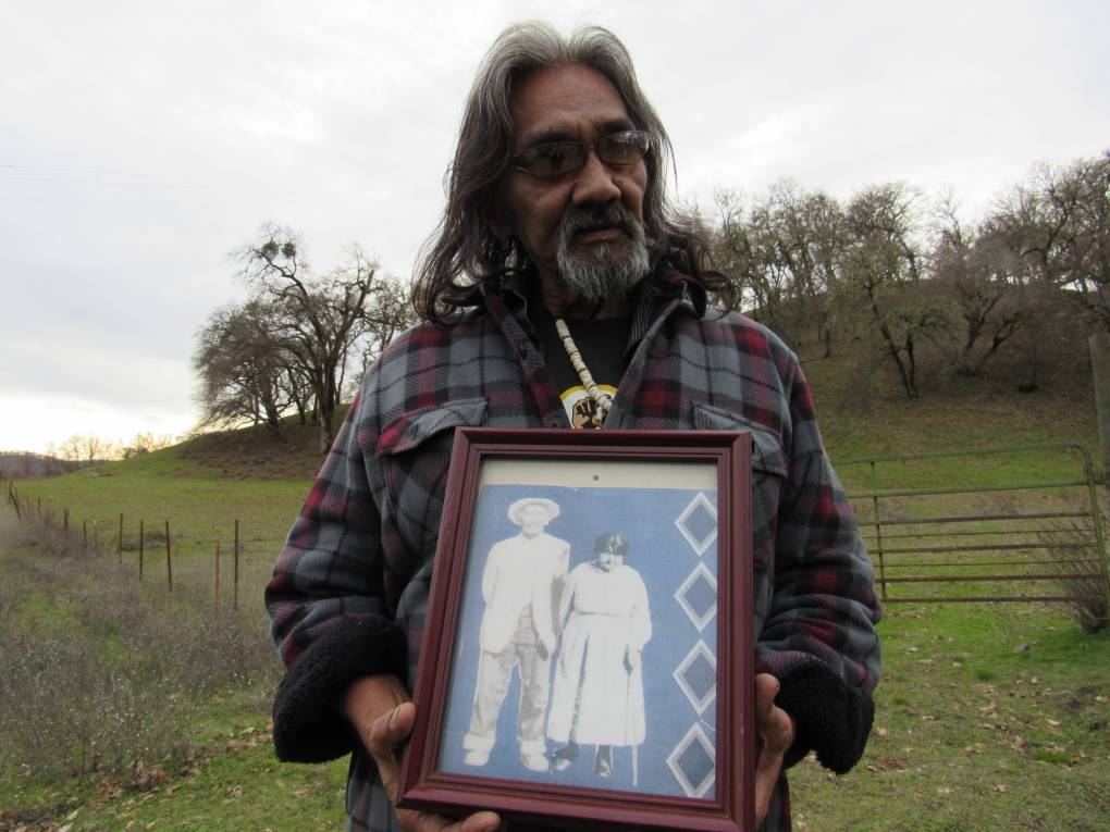 Clayton Duncan holds a framed image of his Great Grandparents, Lucy and Solomon Moore