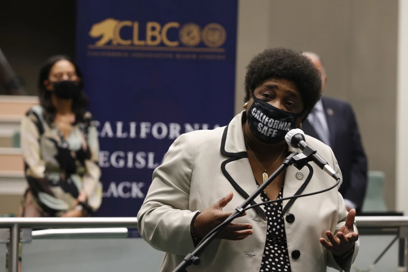 Shirley Weber, now California’s secretary of state, wears a California safe mask while speaking into a microphone (Rich Pedroncelli / Associated Press)
